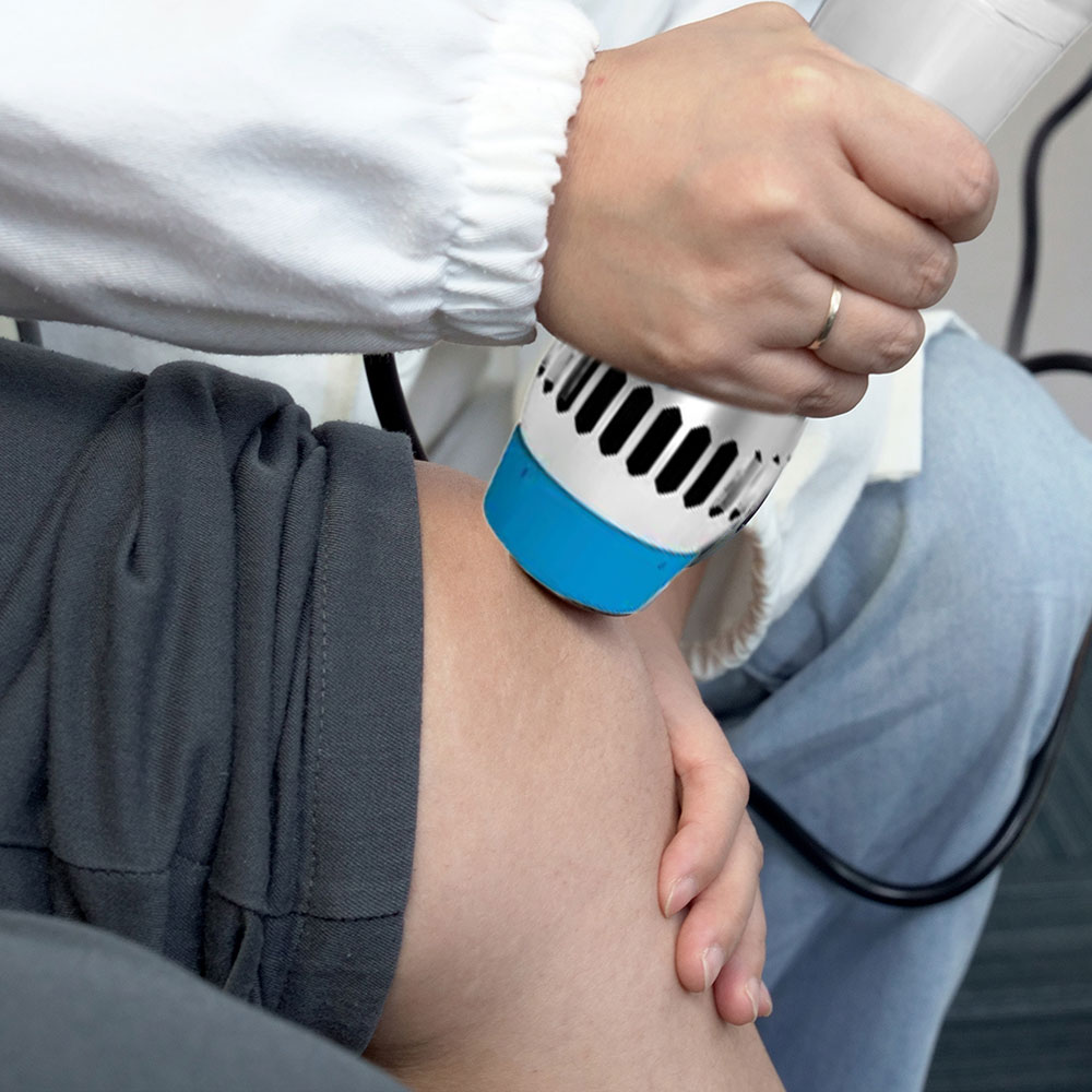 Radial shockwave therapy on the knee for joint pain relief.