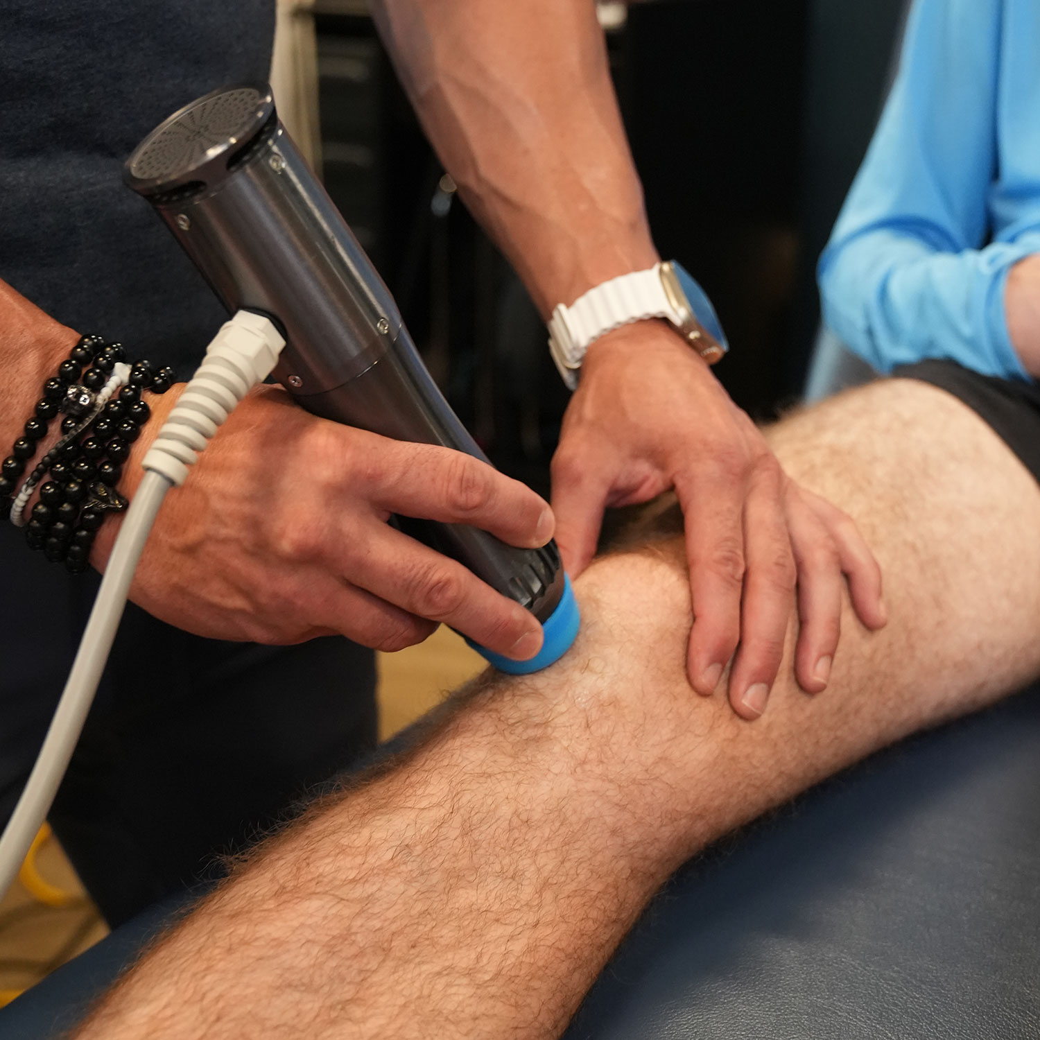Radial shockwave therapy treatment on patient’s knee.