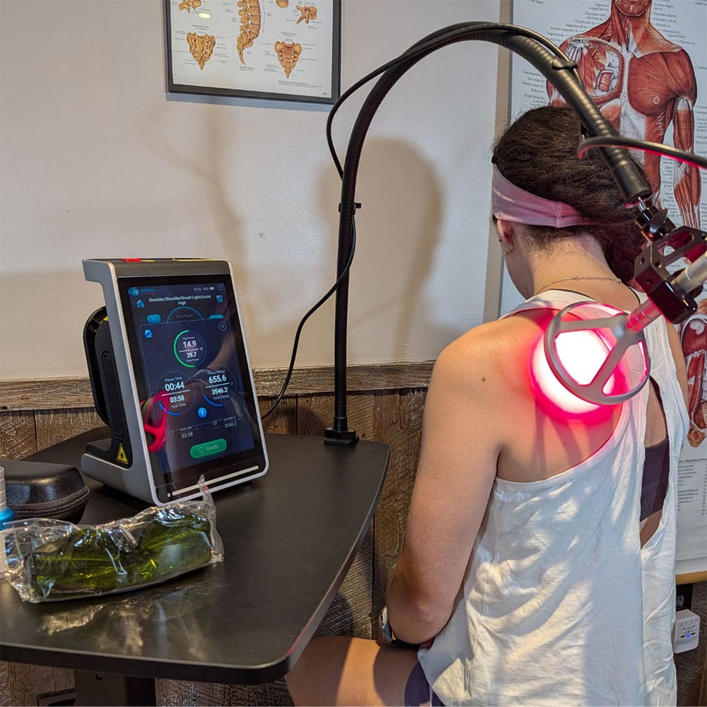 QuantumX Class 4 chiropractic laser in use with S.T.A.R. Hands-Free Therapy System.